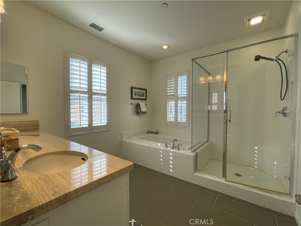 108 Pendant Irvine, CA 92620 - Photo 23 of 36 a bathroom with a granite countertop sink mirror and shower