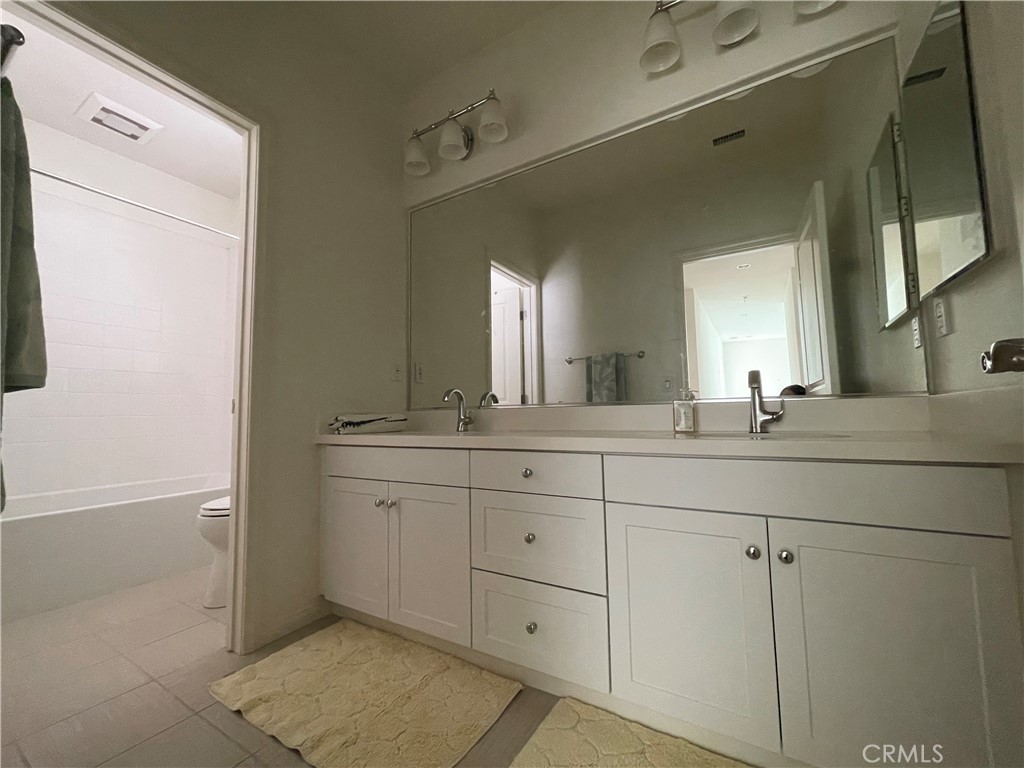 108 Pendant Irvine, CA 92620 - Photo 26 of 36 a bathroom with a double vanity sink and a mirror