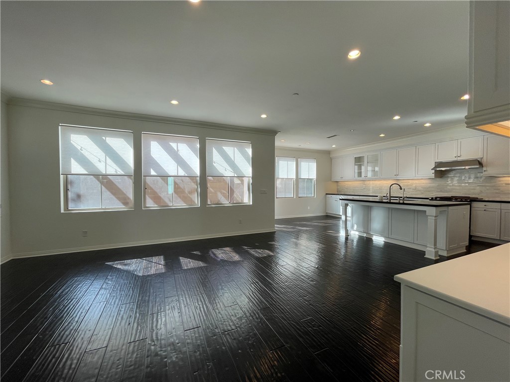 108 Pendant Irvine, CA 92620 - Photo 10 of 36 a view of an empty room with wooden floor and a window