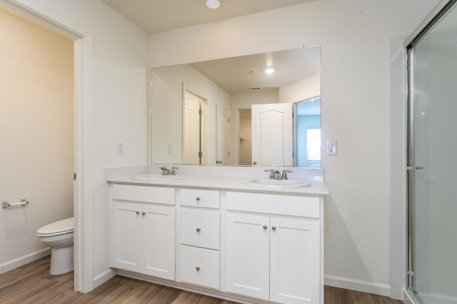 2289 Travis Court Newman, CA 95360 - Photo 15 of 21 a bathroom with a double vanity sink and a toilet