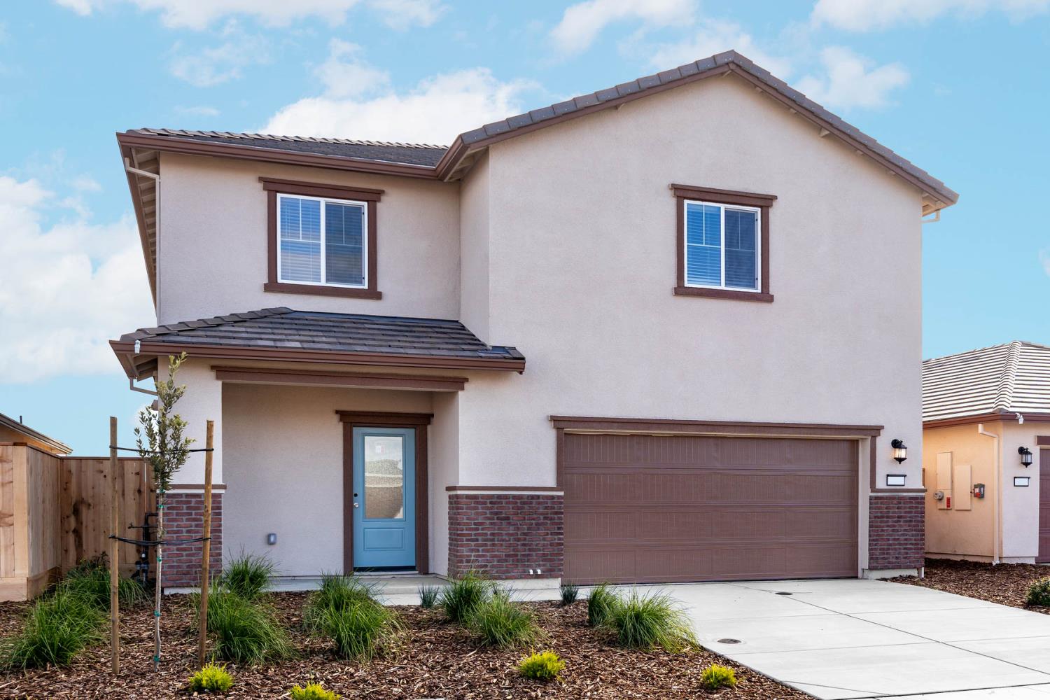 2289 Travis Court Newman, CA 95360 - Photo 2 of 21 a front view of a house with a garden