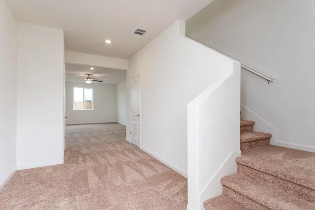a view of an empty room and stairs
