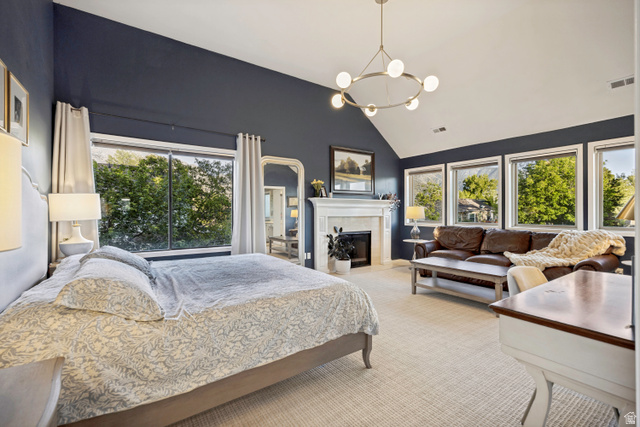 1837 Richard Road Sandy, UT 84093 - Photo 8 of 67 Spacious bedroom featuring high vaulted ceilings, soft neutral carpeting, and a modern chandelier, with a view of the mountains