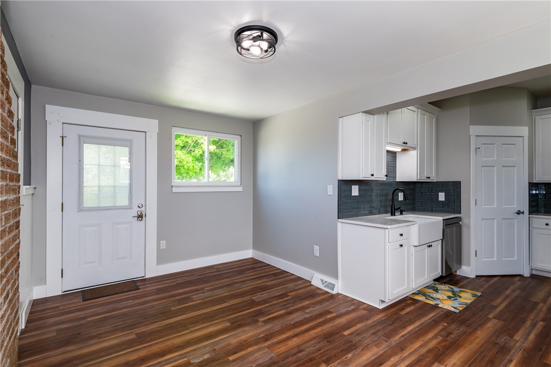 1217 Jasper Road Xenia, OH 45385 - Photo 19 of 62 This bright kitchen and dining area features rich wood flooring, crisp white cabinetry, and modern fixtures.