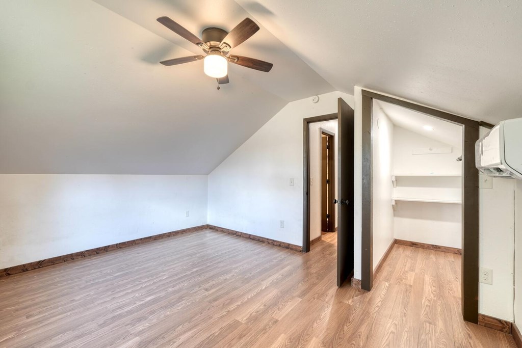 734 Bell Creek Road Hiawassee, GA 30546 - Photo 14 of 30 an empty room with wooden floor fan and windows