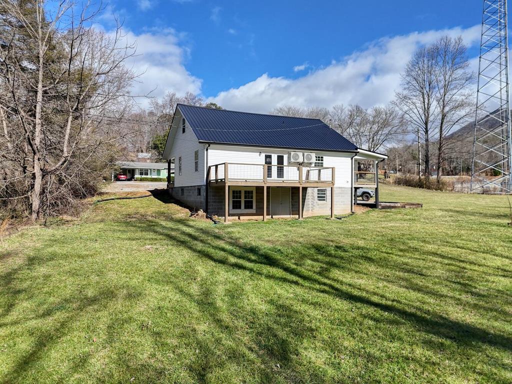 734 Bell Creek Road Hiawassee, GA 30546 - Photo 16 of 30 a view of a house with a big yard and large trees