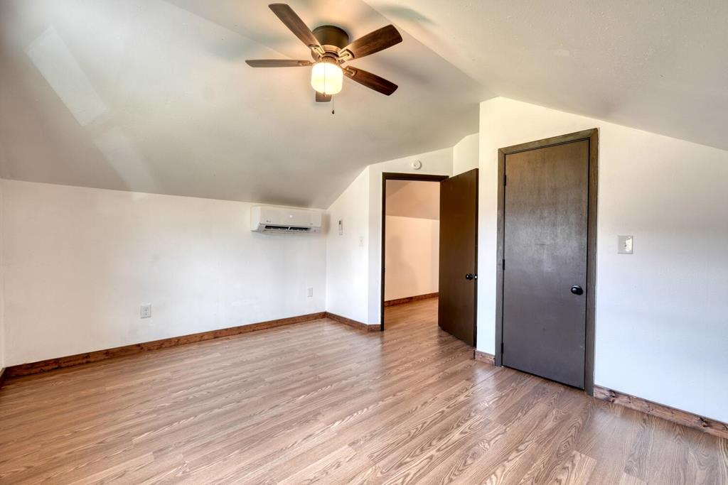 734 Bell Creek Road Hiawassee, GA 30546 - Photo 19 of 30 an empty room with wooden floor closet and fan