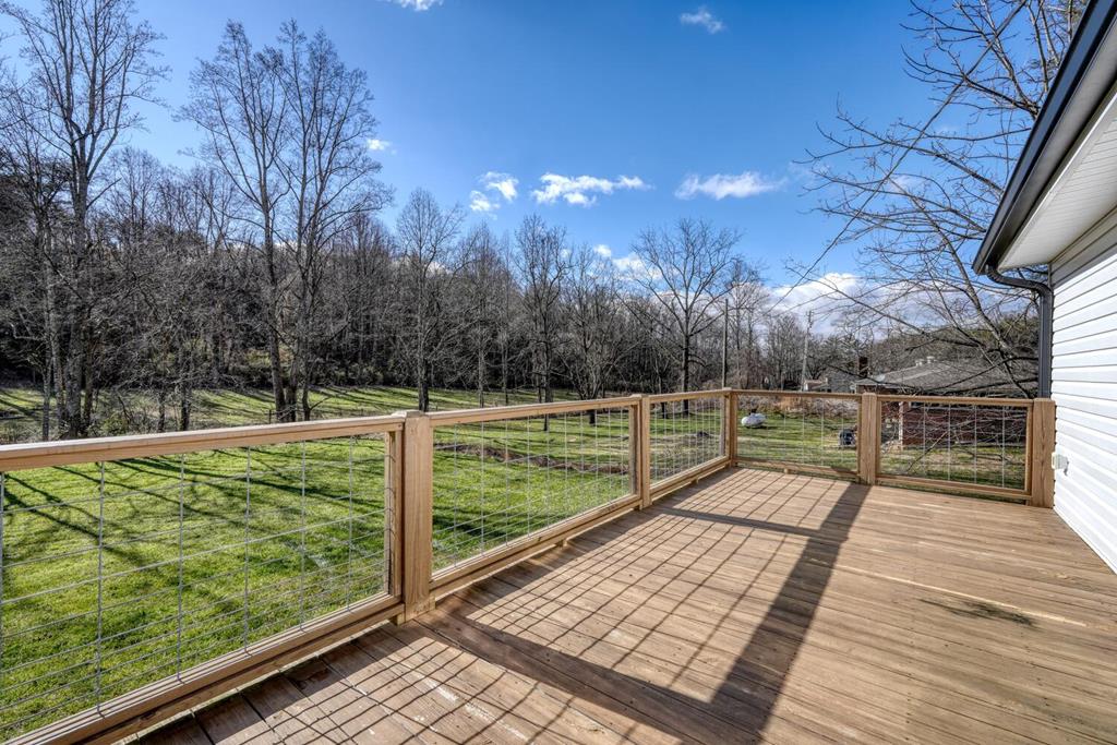734 Bell Creek Road Hiawassee, GA 30546 - Photo 22 of 30 a view of a balcony with wooden floor and fence