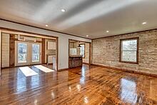 734 Bell Creek Road Hiawassee, GA 30546 - Photo 3 of 30 an empty room with wooden floor and large windows
