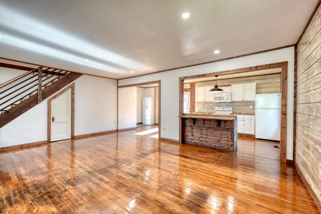 734 Bell Creek Road Hiawassee, GA 30546 - Photo 5 of 30 an empty room with wooden floor and windows