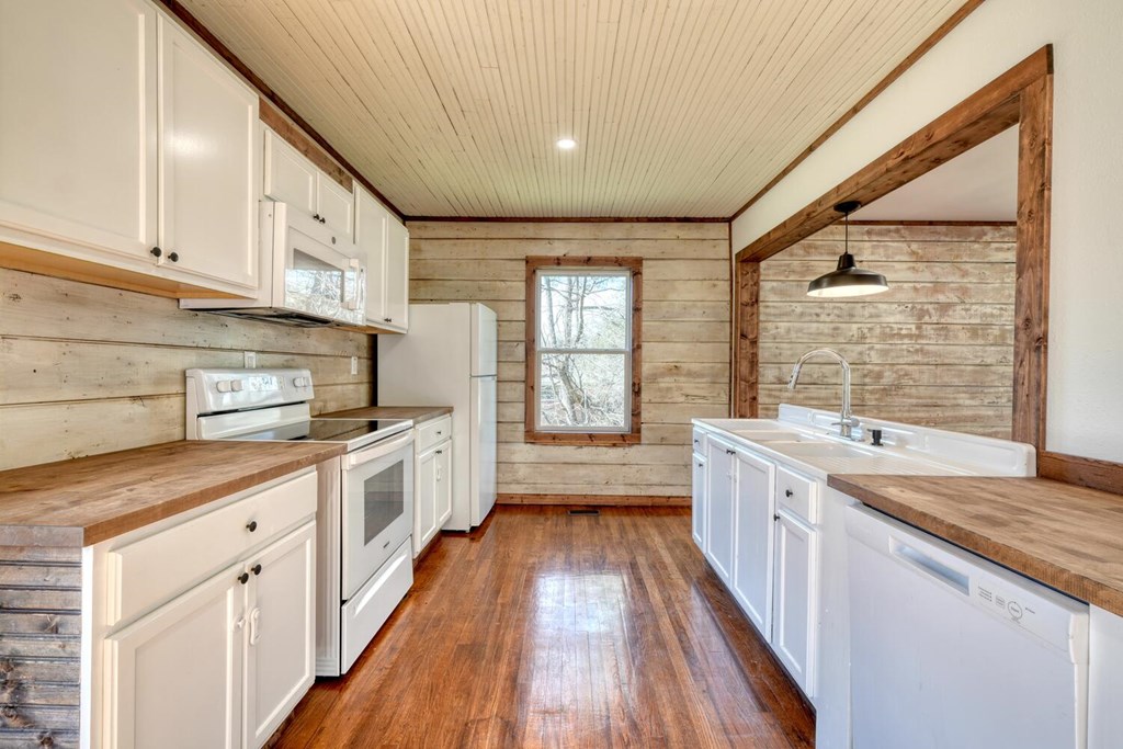 734 Bell Creek Road Hiawassee, GA 30546 - Photo 8 of 30 a large kitchen with a large window a sink and stainless steel appliances
