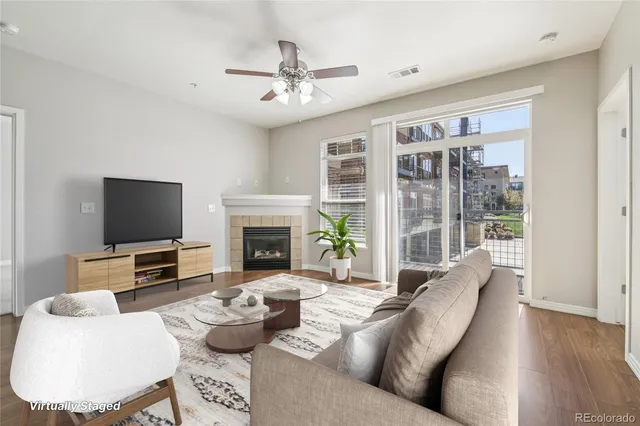 a living room with furniture a flat screen tv and a fireplace