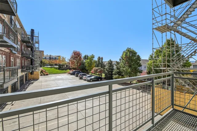 a view of a balcony and trees