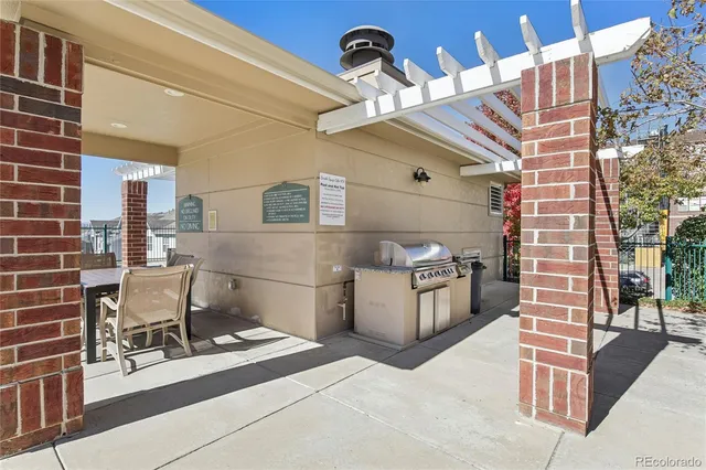 a view of a patio with a table and chairs