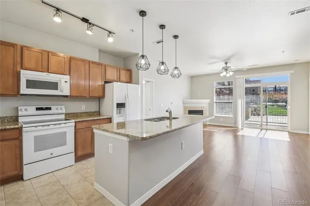 a large kitchen with cabinets wooden floor and stainless steel appliances