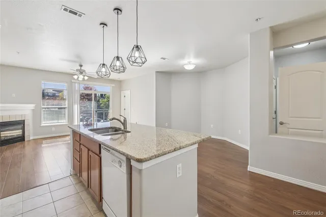 a kitchen with a counter space cabinets and a chandelier