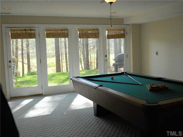 2957 Tillinghast Trail Raleigh, NC 27613 - Photo 15 of 25 Another view of rec room with a wall of windows & doors. Just walk right out to the golf course.