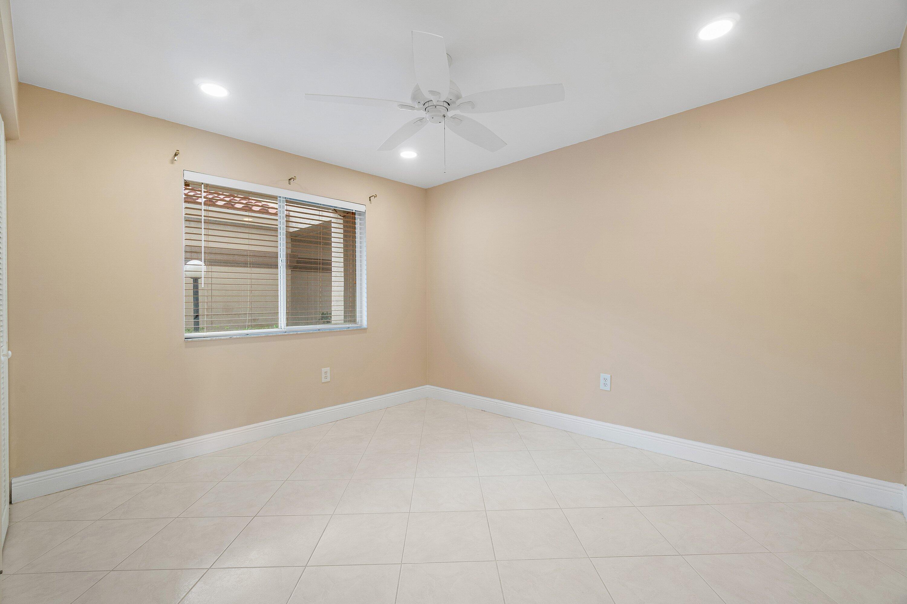 14096 Huntington Pointe Drive, Unit 106 Delray Beach, FL 33484 - Photo 24 of 47 an empty room with windows and closet