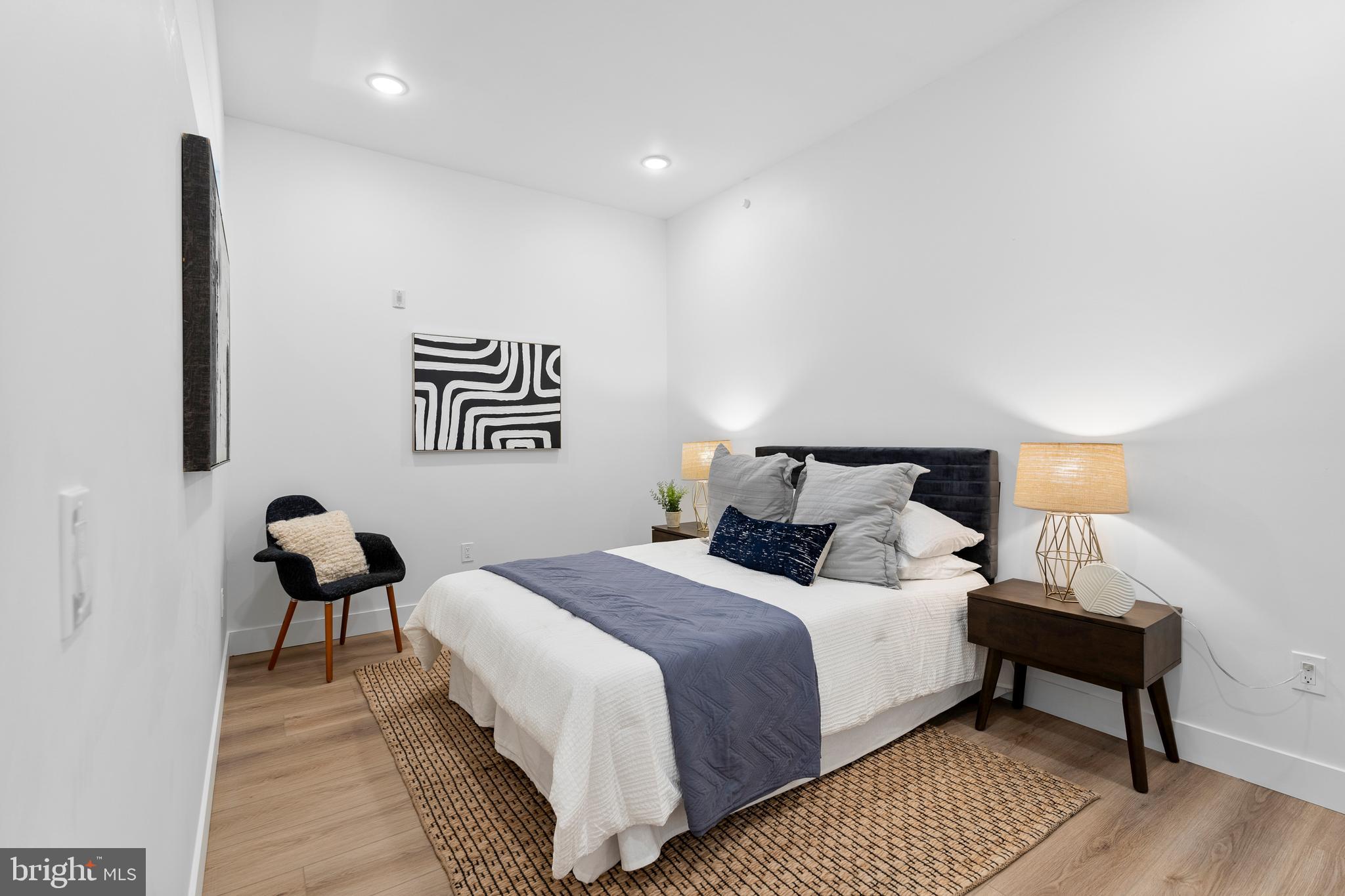 300 Christian Street, Unit 202 Philadelphia, PA 19147 - Photo 11 of 27 a bedroom with a bed and a lamp