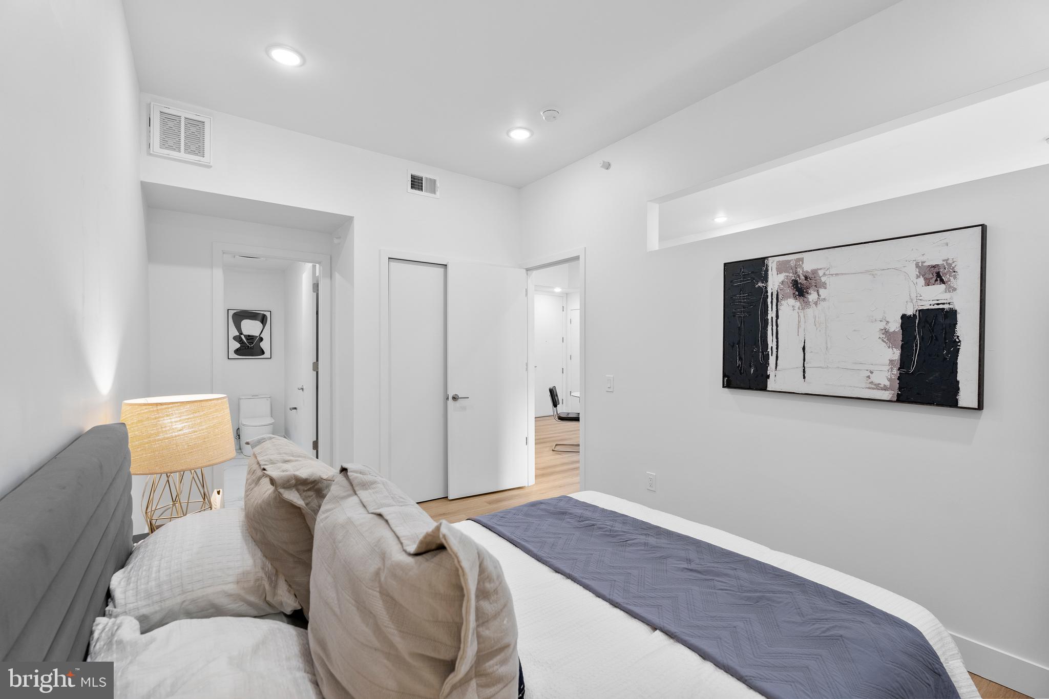 300 Christian Street, Unit 202 Philadelphia, PA 19147 - Photo 13 of 27 a bedroom with a bed and a chair