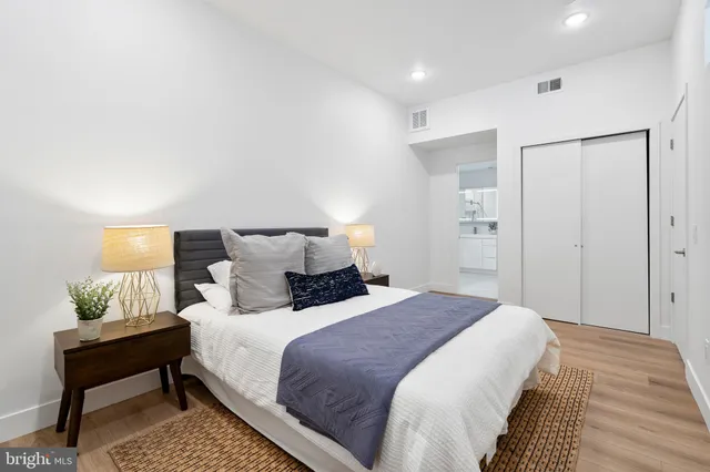 a bedroom with a bed and a lamp