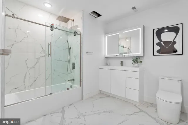 a bathroom with a toilet sink and shower