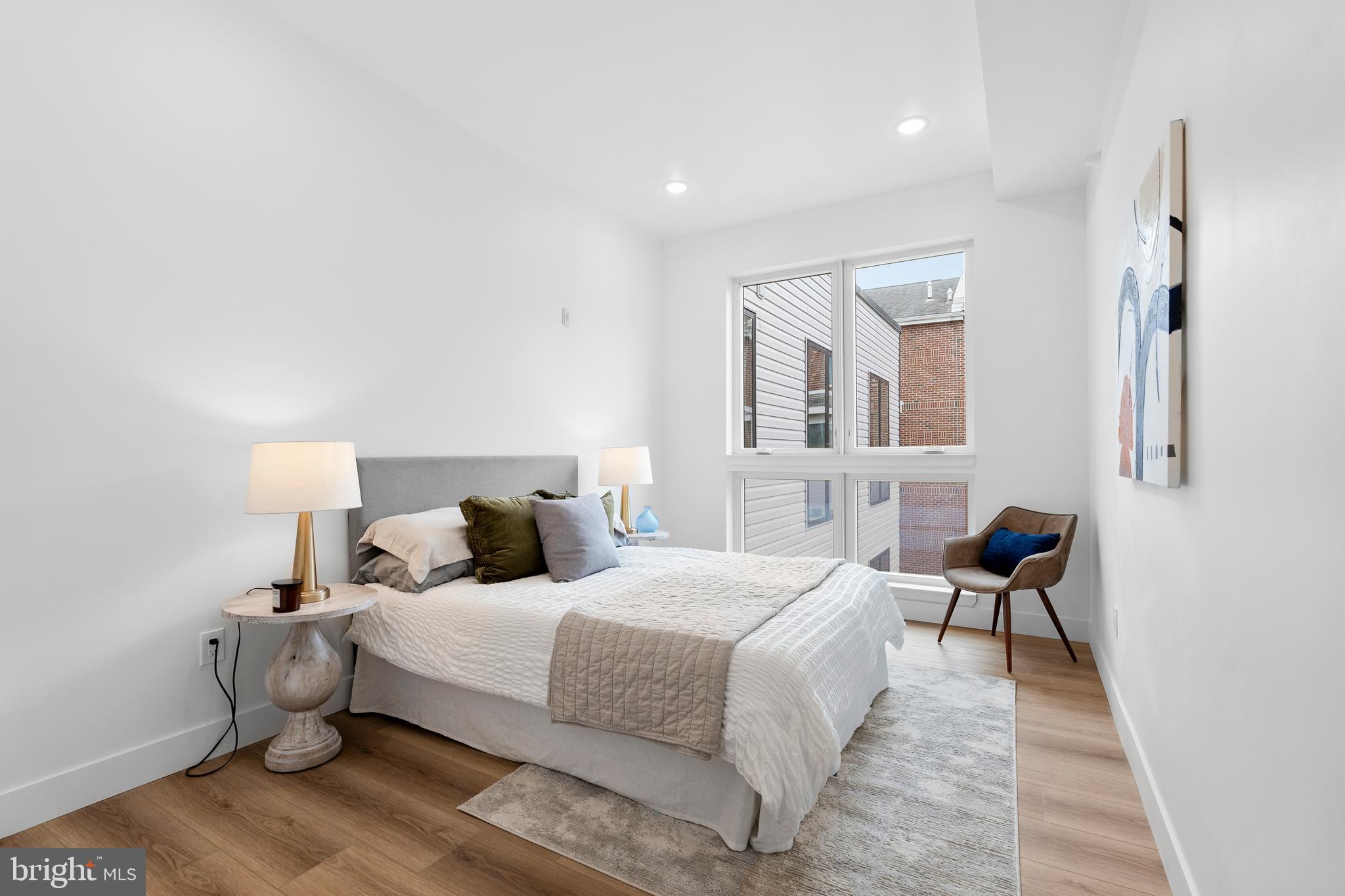 300 Christian Street, Unit 202 Philadelphia, PA 19147 - Photo 16 of 27 a bedroom with a bed and wooden floor