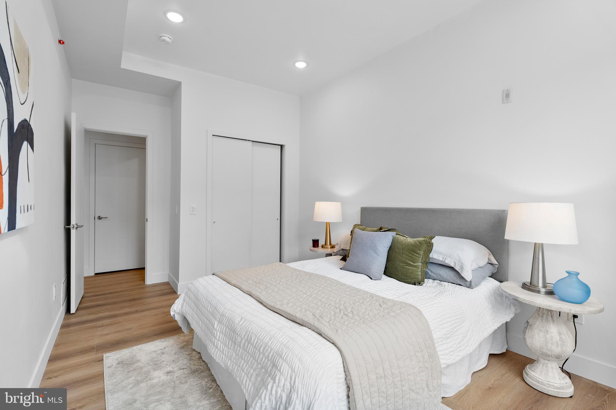 300 Christian Street, Unit 202 Philadelphia, PA 19147 - Photo 17 of 27 a bedroom with a bed and a lamp