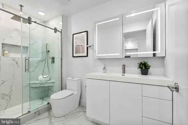 a bathroom with a sink toilet and shower