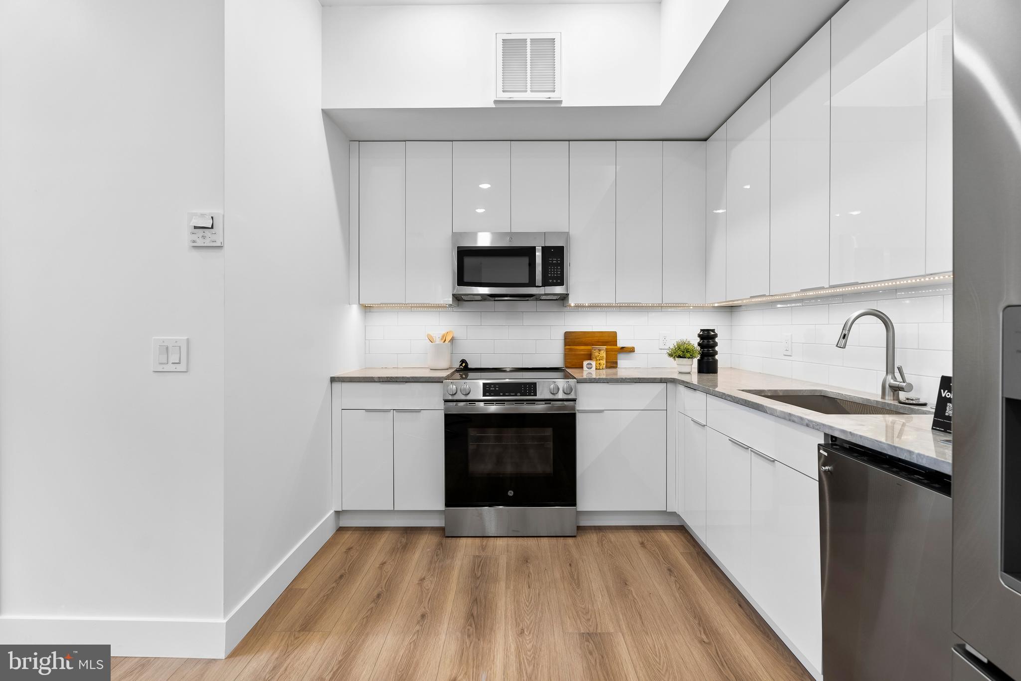 300 Christian Street, Unit 202 Philadelphia, PA 19147 - Photo 7 of 27 a kitchen with a sink and a stove top oven