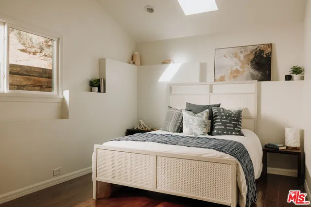 a bedroom with a bed and window