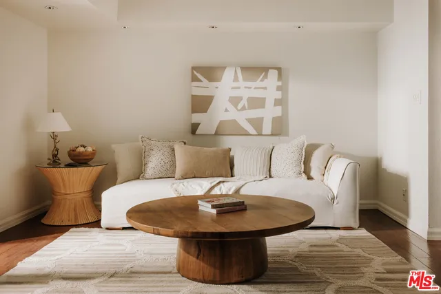 a living room with furniture and a mirror