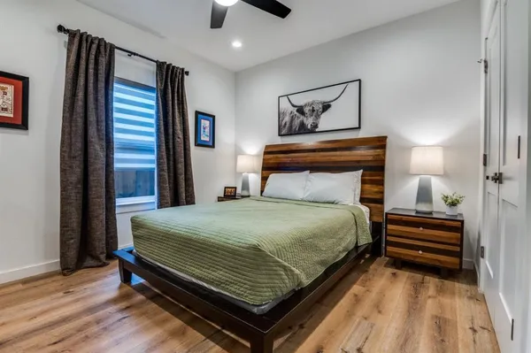 a bedroom with a bed and wooden floor