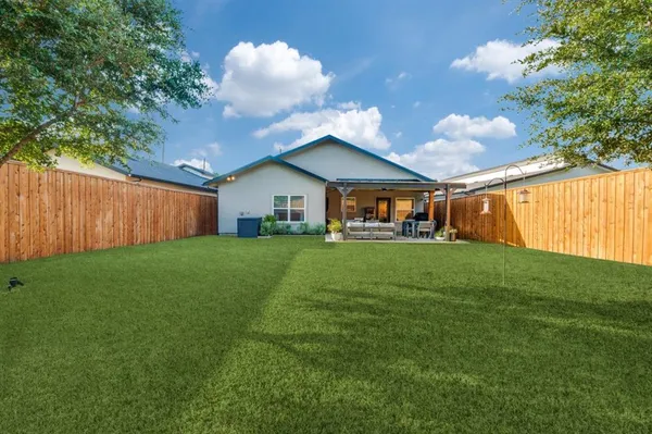 a view of an house with backyard space and garden view