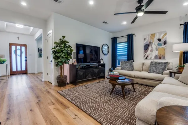 a living room with furniture and a flat screen tv