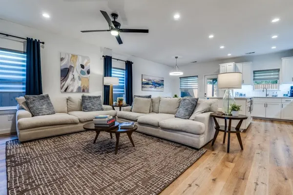 a living room with furniture and a wooden floor