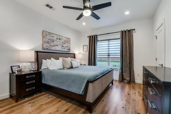 a bedroom with a bed and a flat tv screen