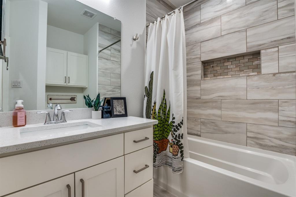 1110 Claude Street Dallas, TX 75203 - Photo 10 of 12 a bathroom with a granite countertop sink a toilet and bathtub