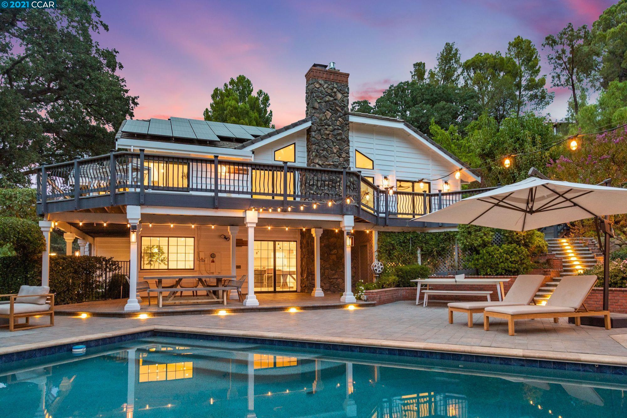 a backyard of a house with yard swimming pool and outdoor seating
