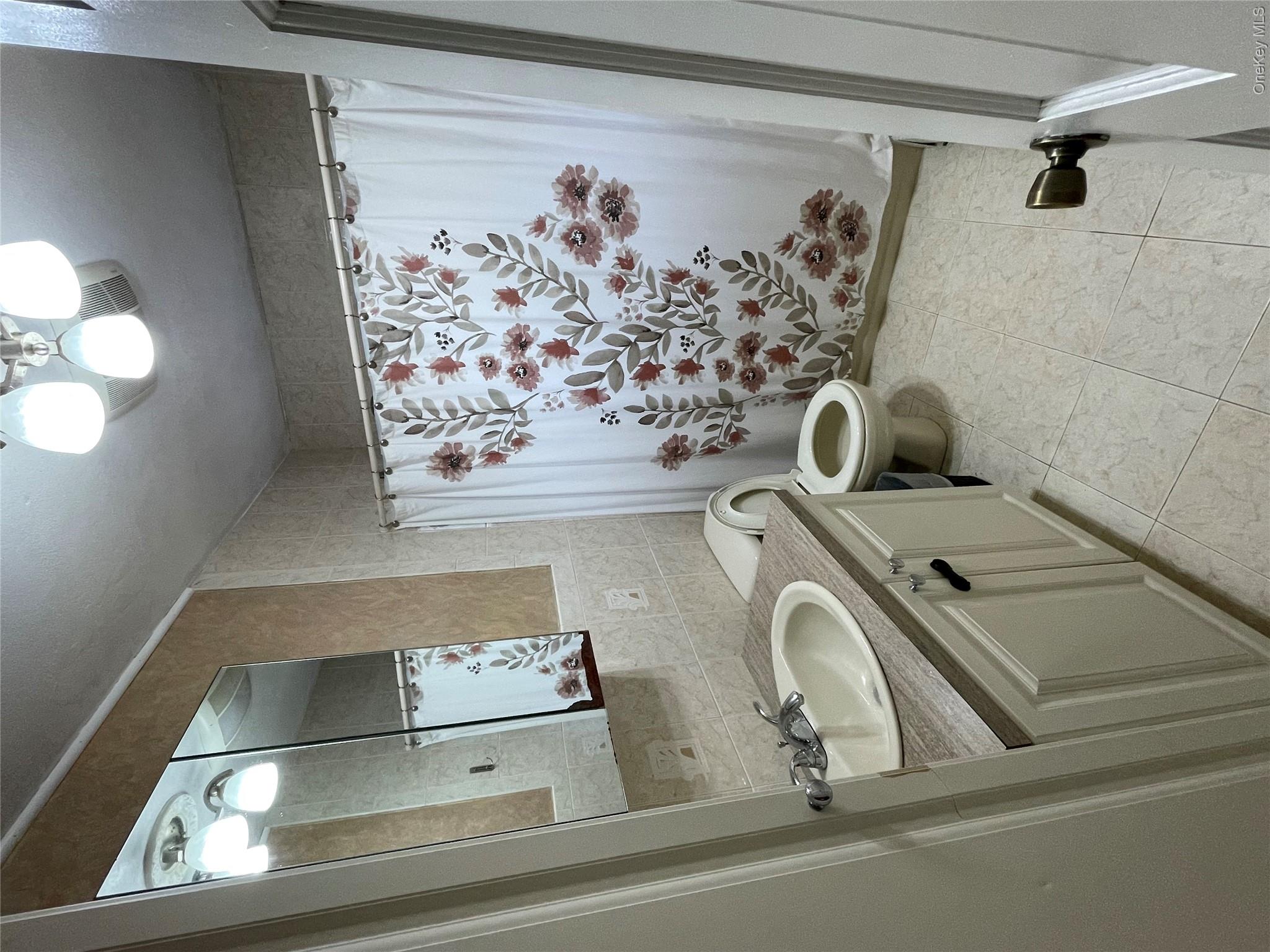 161 Hawkins Road Centereach, NY 11720 - Photo 15 of 16 a bathroom with a granite countertop sink toilet and mirror