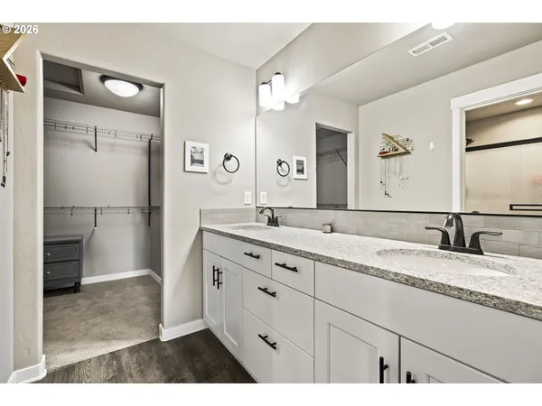 a bathroom with a granite countertop sink mirror and double