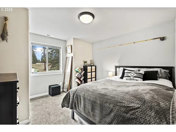 a bedroom with a large bed and a window