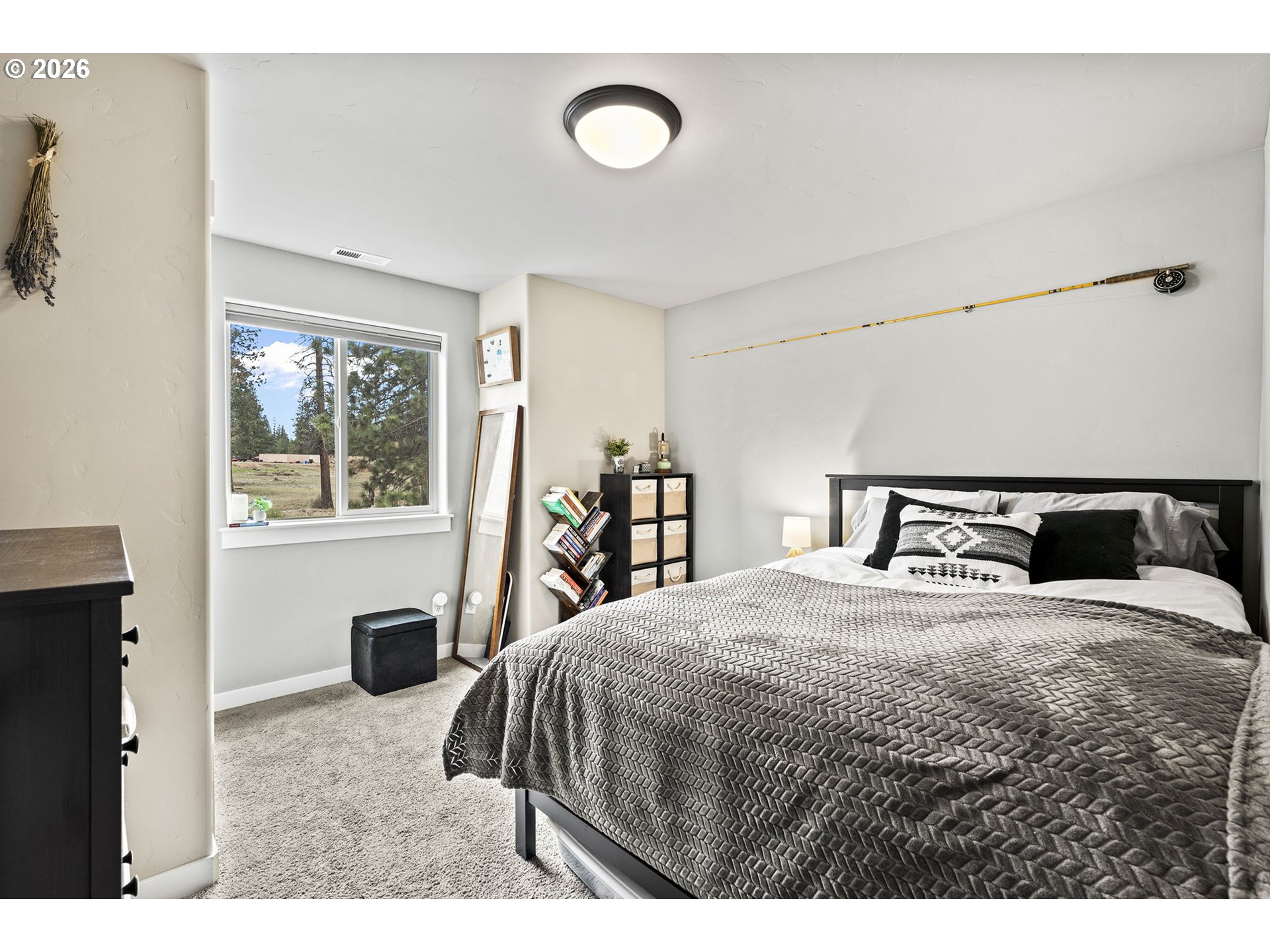 60439 Hedgewood Lane Bend, OR 97702 - Photo 19 of 44 a bedroom with a large bed and a window