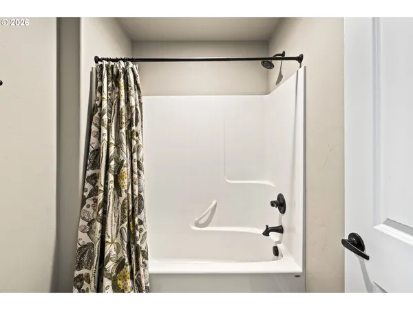 a bathroom with a shower and a tub
