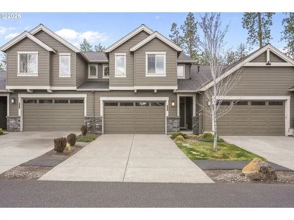 a white house with a yard and parking space