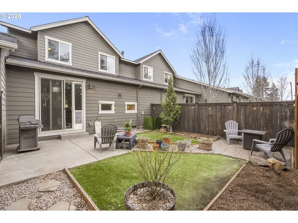 a backyard of a house with table and chairs