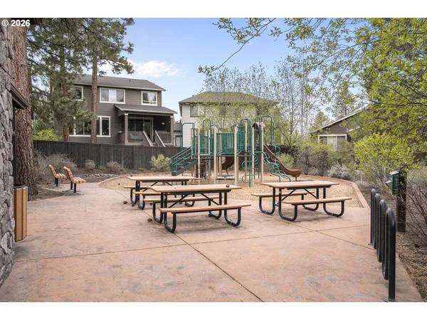a view of a patio with a table and chairs under an umbrella