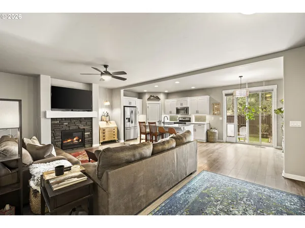 a living room with furniture a fireplace and a flat screen tv