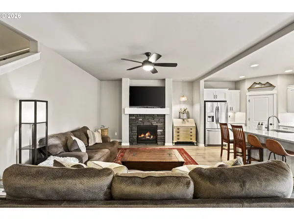 a living room with furniture a fireplace and a chandelier