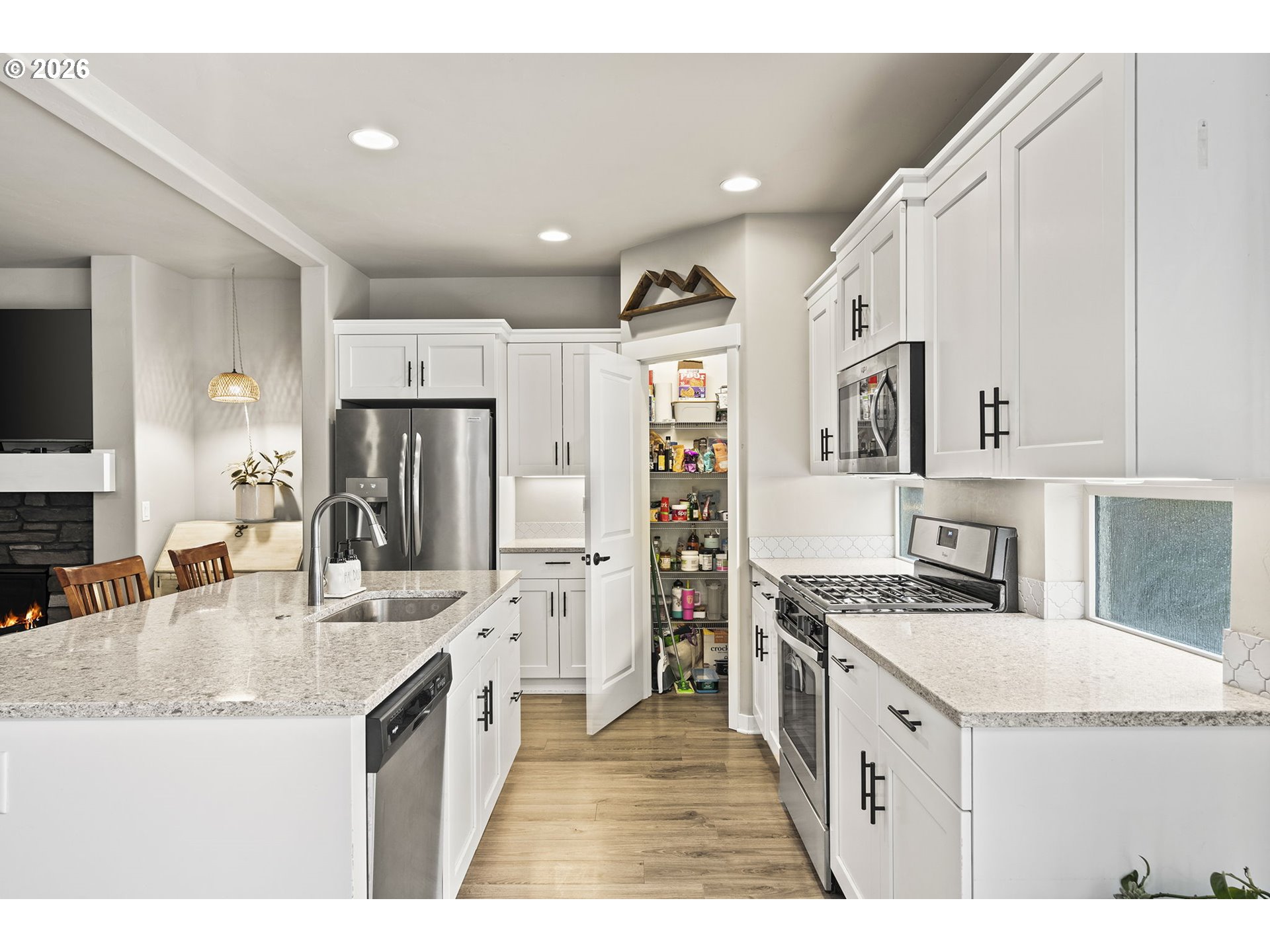 60439 Hedgewood Lane Bend, OR 97702 - Photo 5 of 44 a kitchen with granite countertop a sink stove and refrigerator